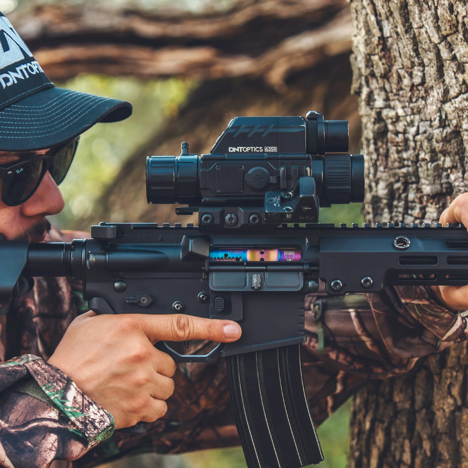 Shooter aiming a rifle mounted with a DNT Optics TNC635R ThermNight scope