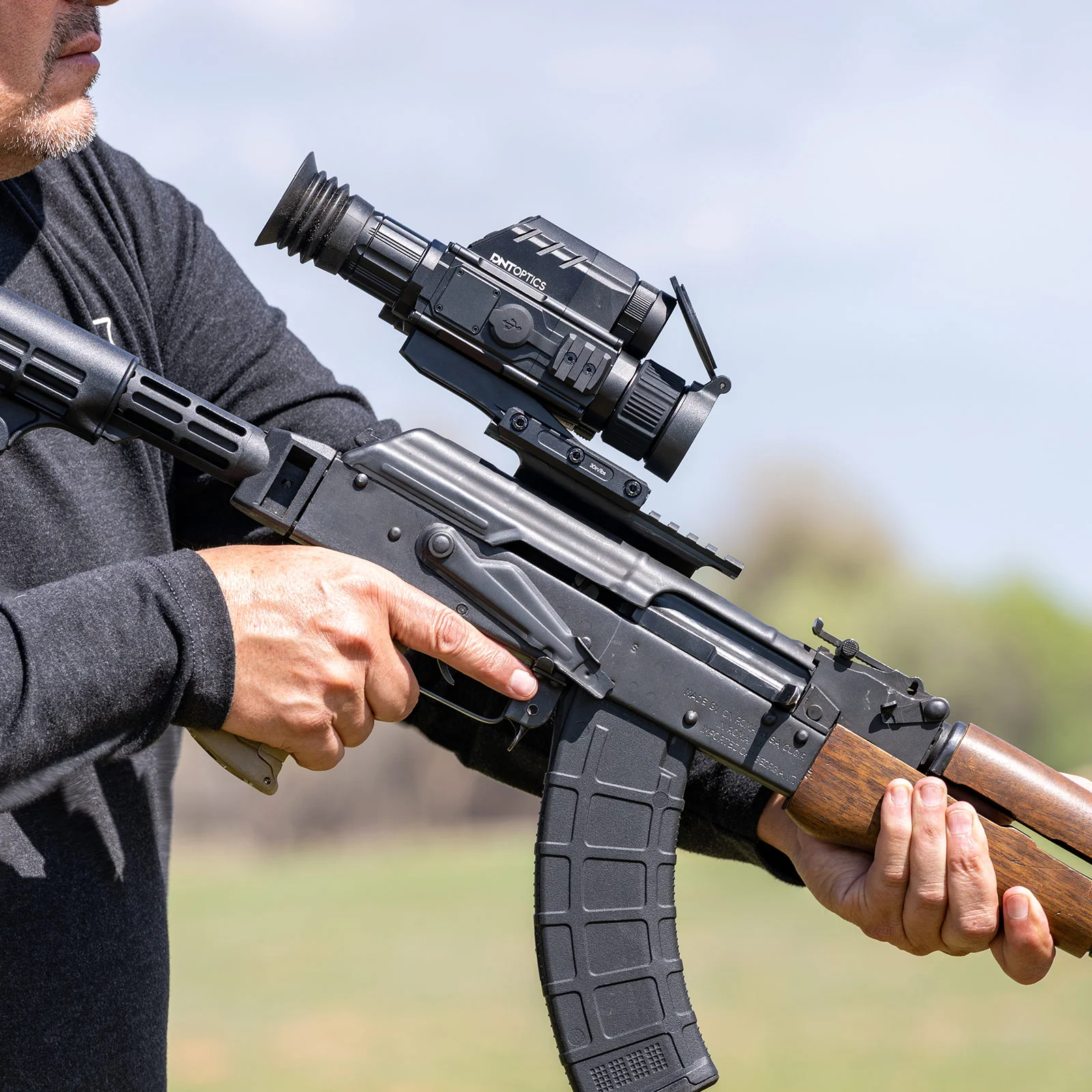 Hunter with a rifle mounted with a DNT Optics ThermNight scope