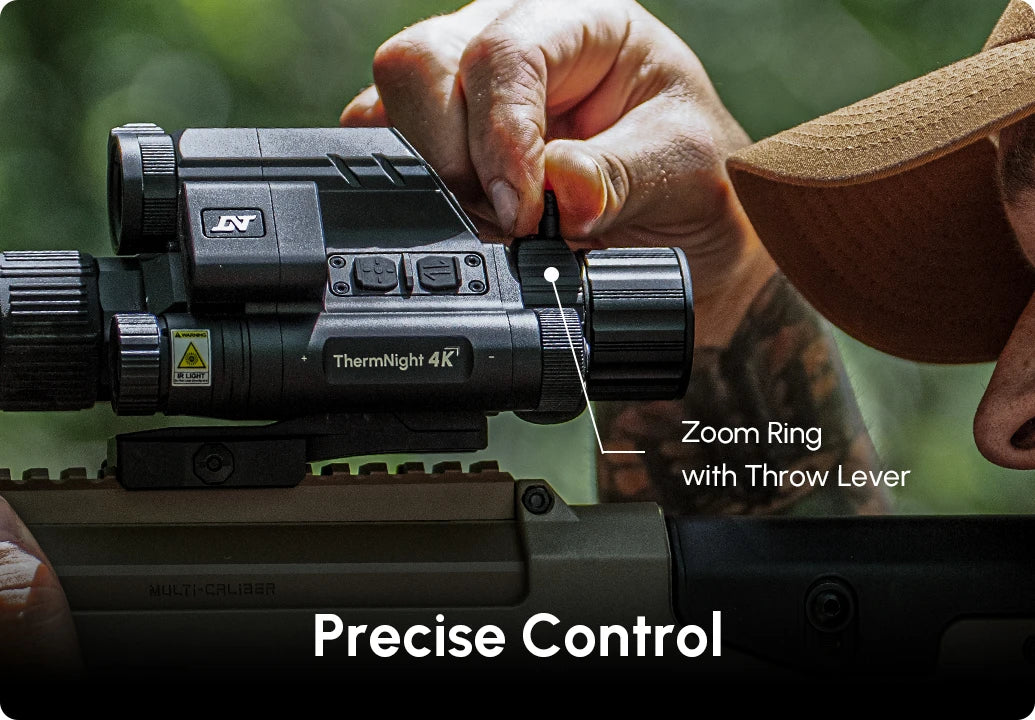 Hand adjusting the zoom ring and throw lever on a DNT Optics TNC4K219R ThermNight 4K scope